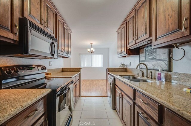 5400 Newcastle Ave Unit 56, Encino, CA 91316 - kitchen featuring a sink, light stone counters, black appliances, and a notable chandelier