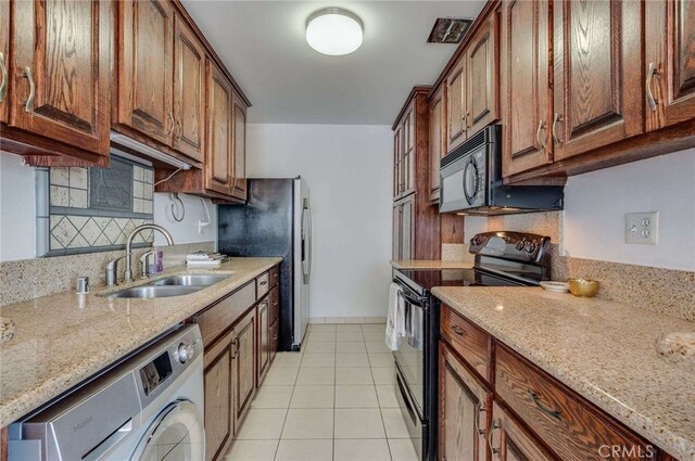 5400 Newcastle Ave Unit 56, Encino, CA 91316 - kitchen with a sink, light stone countertops, black appliances, and light tile patterned flooring