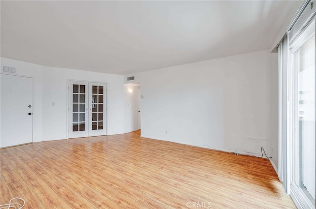 5400 Newcastle Ave Unit 56, Encino, CA 91316 - spare room with visible vents, wood finished floors, a wealth of natural light, and french doors