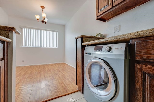 5400 Newcastle Ave Unit 56, Encino, CA 91316 - laundry room featuring baseboards, washer / clothes dryer, cabinet space, light wood-style flooring, and a notable chandelier