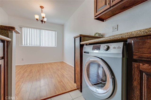 5400 Newcastle Ave Unit 56, Encino, CA 91316 - washroom with washer / clothes dryer, a chandelier, light wood finished floors, and cabinet space