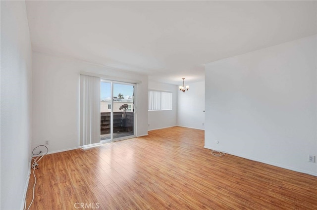 5400 Newcastle Ave Unit 56, Encino, CA 91316 - unfurnished room featuring light wood-style flooring and a chandelier