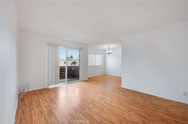 5400 Newcastle Ave Unit 56, Encino, CA 91316 - unfurnished room with a chandelier and light wood-style flooring