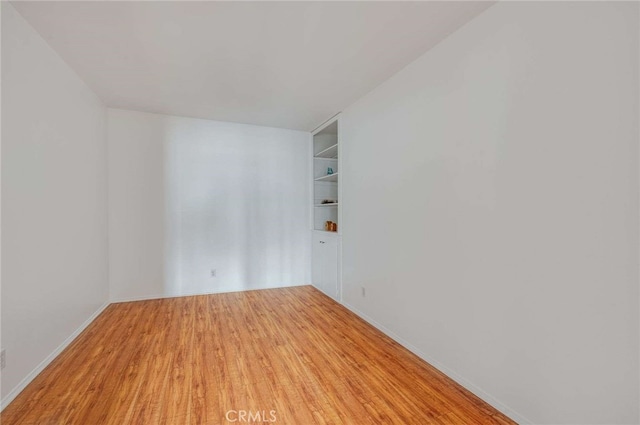 5400 Newcastle Ave Unit 56, Encino, CA 91316 - spare room featuring light wood-style floors, baseboards, and built in shelves