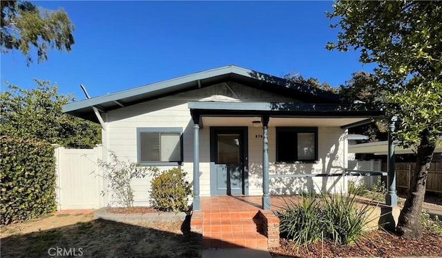 bungalow with fence and covered porch