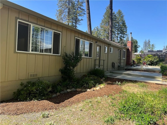 6322 Harvey, Paradise, CA 95969 - view of side of home featuring board and batten siding, a patio area, and fence