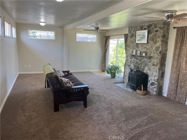 6322 Harvey, Paradise, CA 95969 - living room with a healthy amount of sunlight, carpet floors, a wood stove, and a ceiling fan