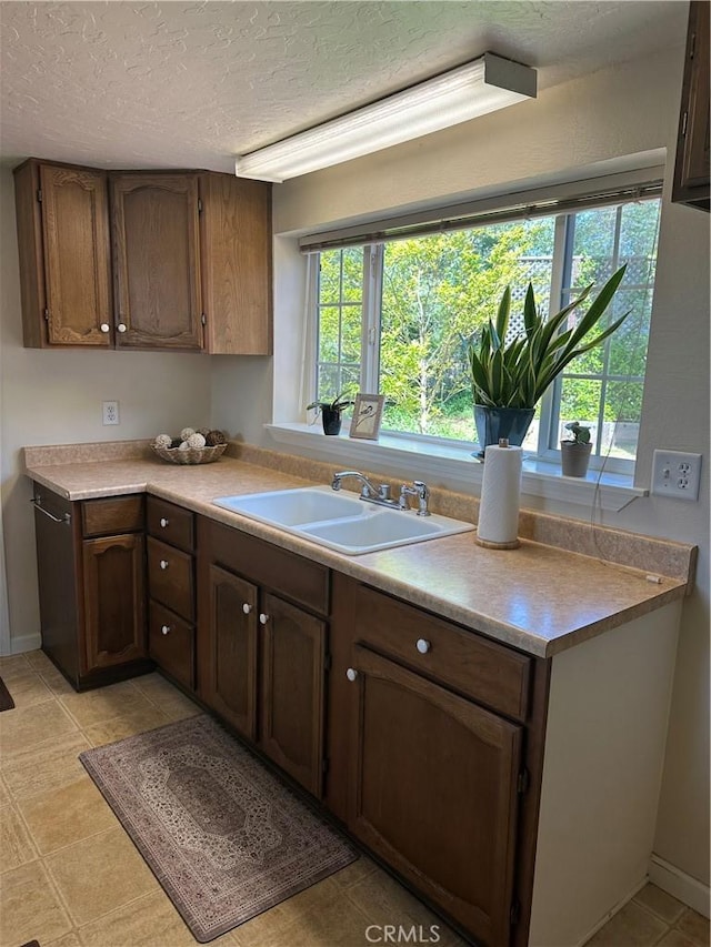 6322 Harvey, Paradise, CA 95969 - kitchen with baseboards, a sink, a textured ceiling, and light countertops