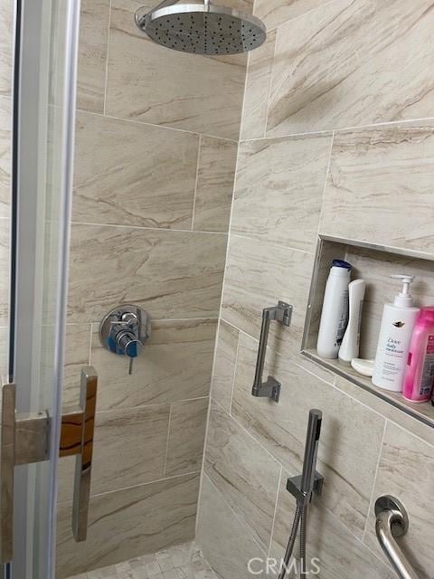 full bath with a tile shower