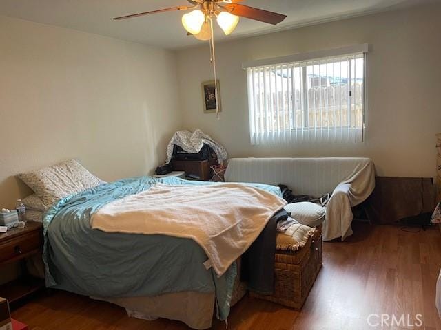 bedroom featuring ceiling fan and wood finished floors