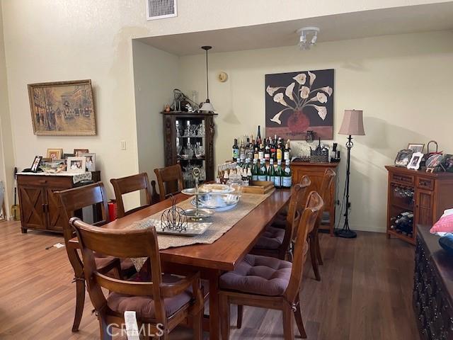 dining area with visible vents and wood finished floors