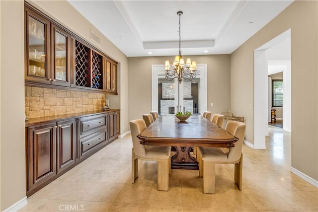 27 Calle Canela, San Clemente, CA 92673 - dining room featuring a notable chandelier, baseboards, light tile patterned floors, a tray ceiling, and visible vents
