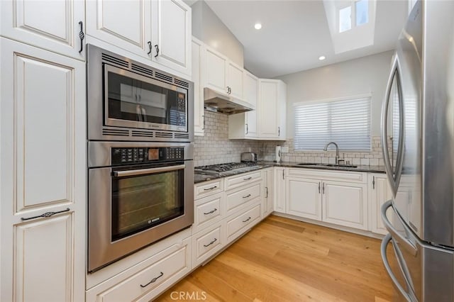 16512 23rd St, Sunset Beach, CA 90742 - kitchen with a sink, tasteful backsplash, under cabinet range hood, and appliances with stainless steel finishes