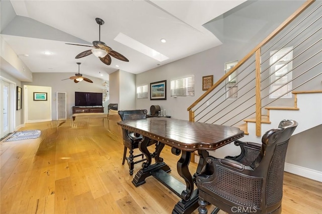 16512 23rd St, Sunset Beach, CA 90742 - dining room featuring a wealth of natural light, ceiling fan, stairs, hardwood / wood-style flooring, and vaulted ceiling with skylight