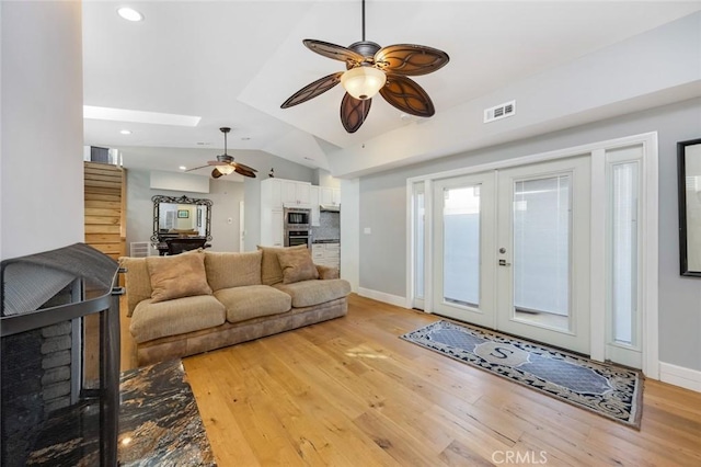 16512 23rd St, Sunset Beach, CA 90742 - living area with french doors, light wood-style flooring, a ceiling fan, baseboards, and lofted ceiling