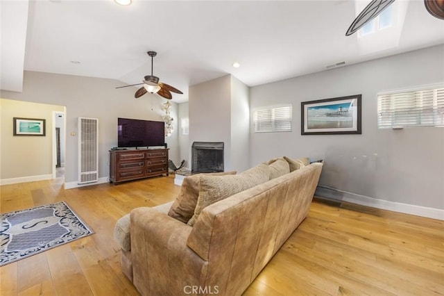 16512 23rd St, Sunset Beach, CA 90742 - living room featuring ceiling fan, light wood-style flooring, baseboards, and a heating unit
