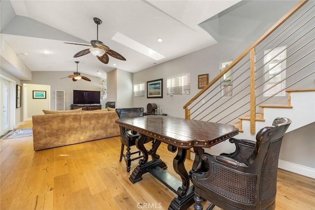 16512 23rd St, Sunset Beach, CA 90742 - dining space featuring stairs, lofted ceiling with skylight, hardwood / wood-style floors, and ceiling fan