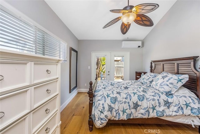 16512 23rd St, Sunset Beach, CA 90742 - bedroom featuring access to exterior, a wall mounted AC, light wood finished floors, a ceiling fan, and baseboards