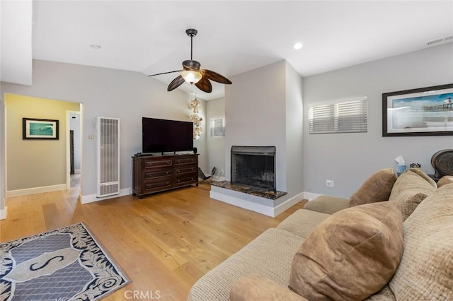 16512 23rd St, Sunset Beach, CA 90742 - living room with baseboards, a heating unit, a multi sided fireplace, and a ceiling fan
