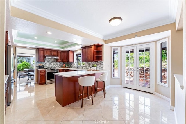 2223 E Vista Mesa Way, Orange, CA 92867 - kitchen with stainless steel appliances, under cabinet range hood, crown molding, open shelves, and a raised ceiling