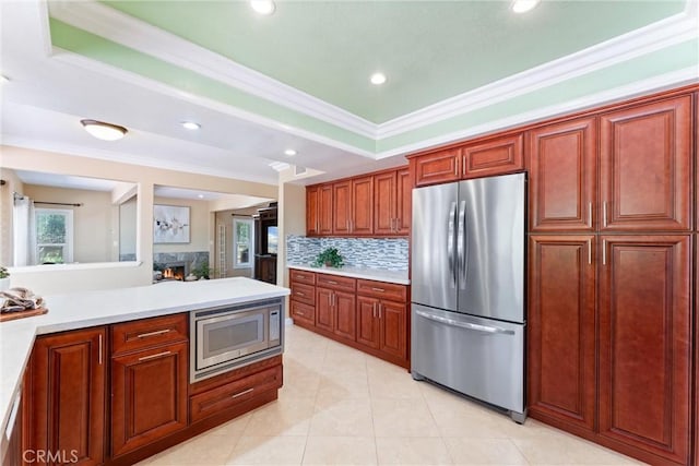 2223 E Vista Mesa Way, Orange, CA 92867 - kitchen with appliances with stainless steel finishes, light countertops, tasteful backsplash, ornamental molding, and a lit fireplace