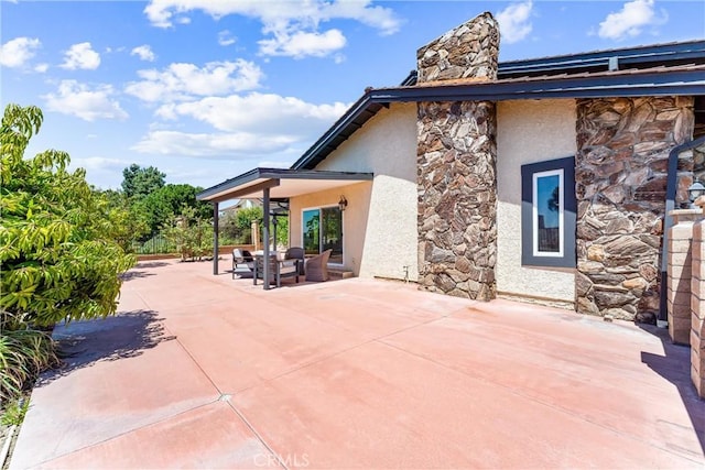 2223 E Vista Mesa Way, Orange, CA 92867 - back of property featuring stone siding, stucco siding, a patio area, and a chimney