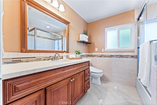 2223 E Vista Mesa Way, Orange, CA 92867 - bathroom featuring vanity, tile walls, toilet, shower / bath combination with glass door, and a wainscoted wall