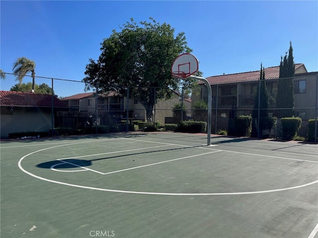 view of basketball court with fence and community basketball court