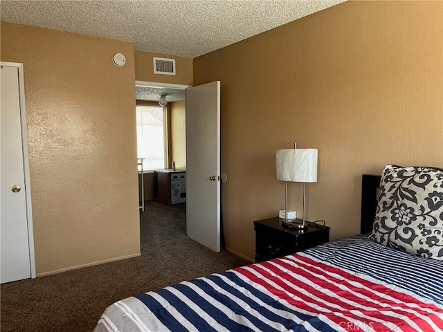 carpeted bedroom with visible vents and a textured ceiling