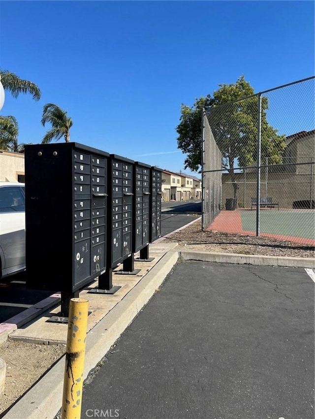 surrounding community featuring fence and mail area