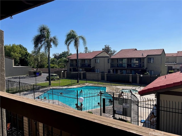 pool with fence and a residential view