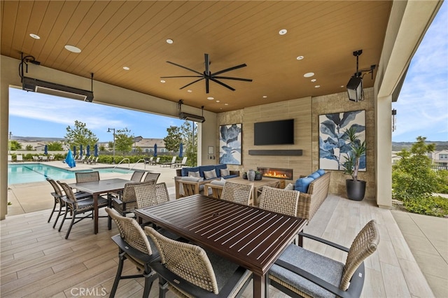 31 Jubilee Way, Rancho Mission Viejo, CA 92694 - view of patio / terrace featuring outdoor dining space, a community pool, ceiling fan, and an outdoor living space with a fireplace