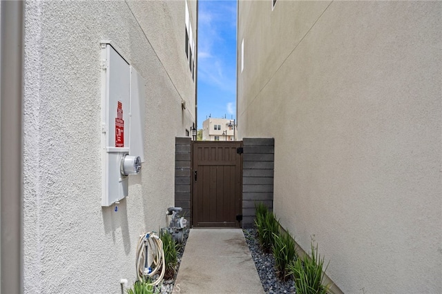 view of property exterior with a gate and stucco siding