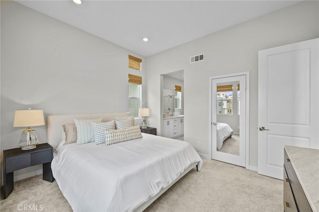bedroom featuring light carpet, ensuite bath, recessed lighting, baseboards, and visible vents