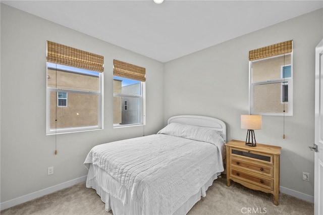 bedroom with carpet floors and baseboards