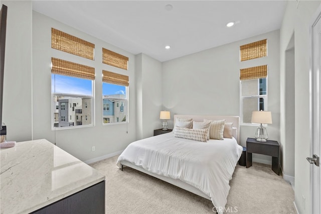 bedroom featuring recessed lighting, baseboards, and light colored carpet