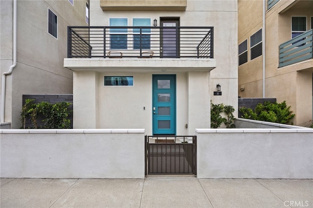 31 Jubilee Way, Rancho Mission Viejo, CA 92694 - view of exterior entry featuring a balcony, stucco siding, and a gate