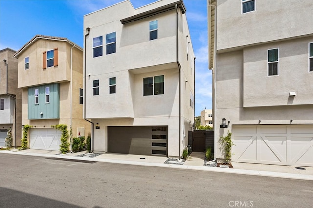 multi unit property with a garage and stucco siding
