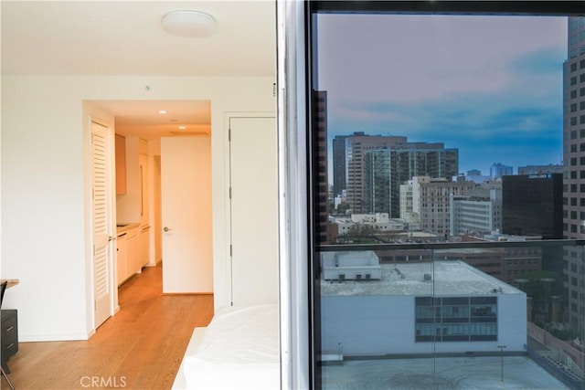interior space with a view of city and wood finished floors