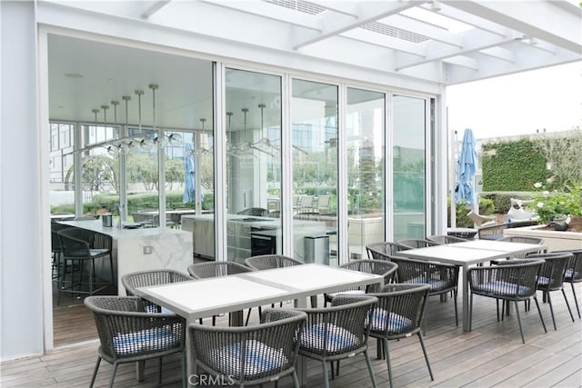 sunroom / solarium featuring beam ceiling