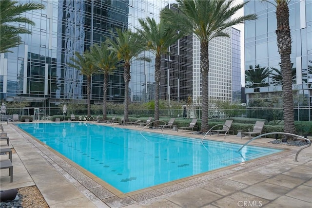 pool with fence and a patio area