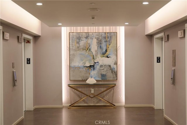 corridor with recessed lighting, baseboards, and wood finished floors