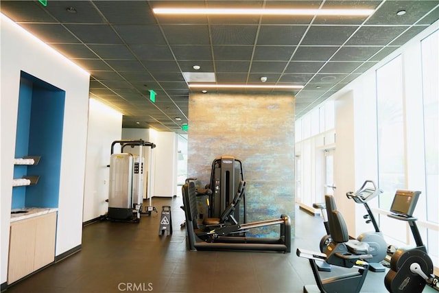gym with a wealth of natural light and a paneled ceiling