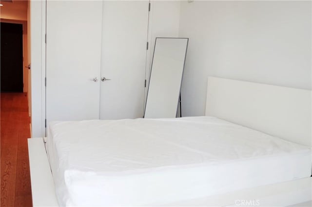 bedroom featuring a closet and wood finished floors