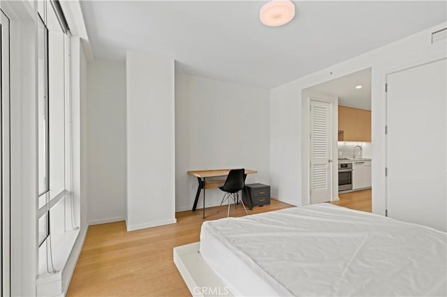 877 Francisco St Unit 1723, Los Angeles, CA 90017 - bedroom featuring a sink, light wood finished floors, baseboards, and recessed lighting