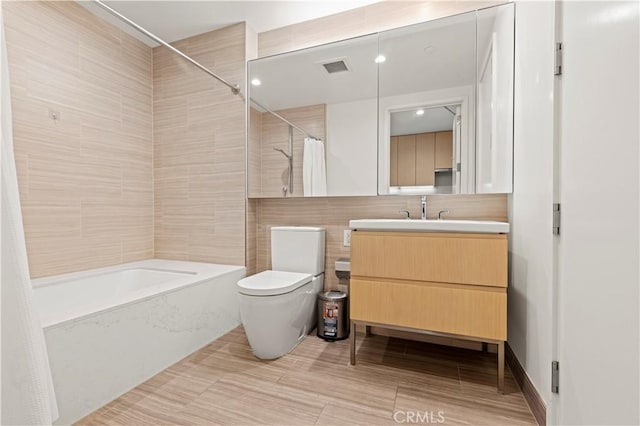 877 Francisco St Unit 1723, Los Angeles, CA 90017 - full bathroom with toilet, tile walls, vanity, and shower / tub combo with curtain