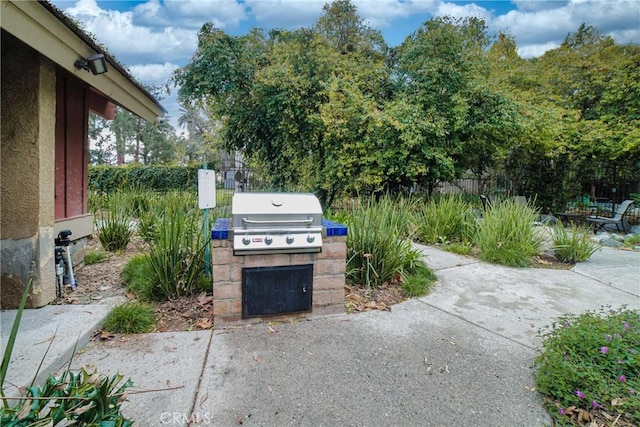 view of patio featuring fence and area for grilling
