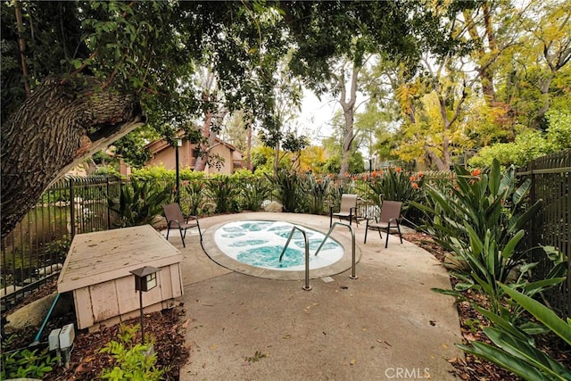 view of pool with a fenced backyard, an in ground hot tub, and a patio area