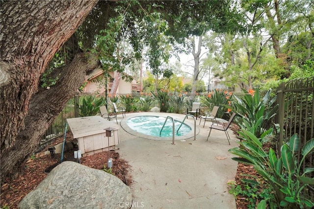 view of swimming pool with a fenced backyard and a patio
