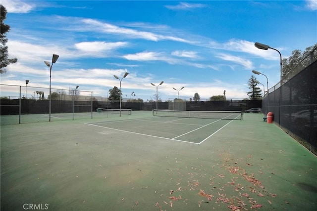 view of sport court featuring fence